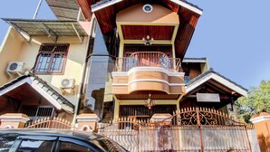 A multi-story house with a balcony, a gated entrance, and solar panels on the roof. - Hotel O Griya Pius Syariah Malioboro (Yogyakarta)