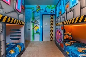A room with bunk beds, a door with a Minion character, and a wall with a Minion-themed mural. - 3508 Lavender Windsor · New Luxury Home | Windsor Island by Disney w/Pool (Davenport)
