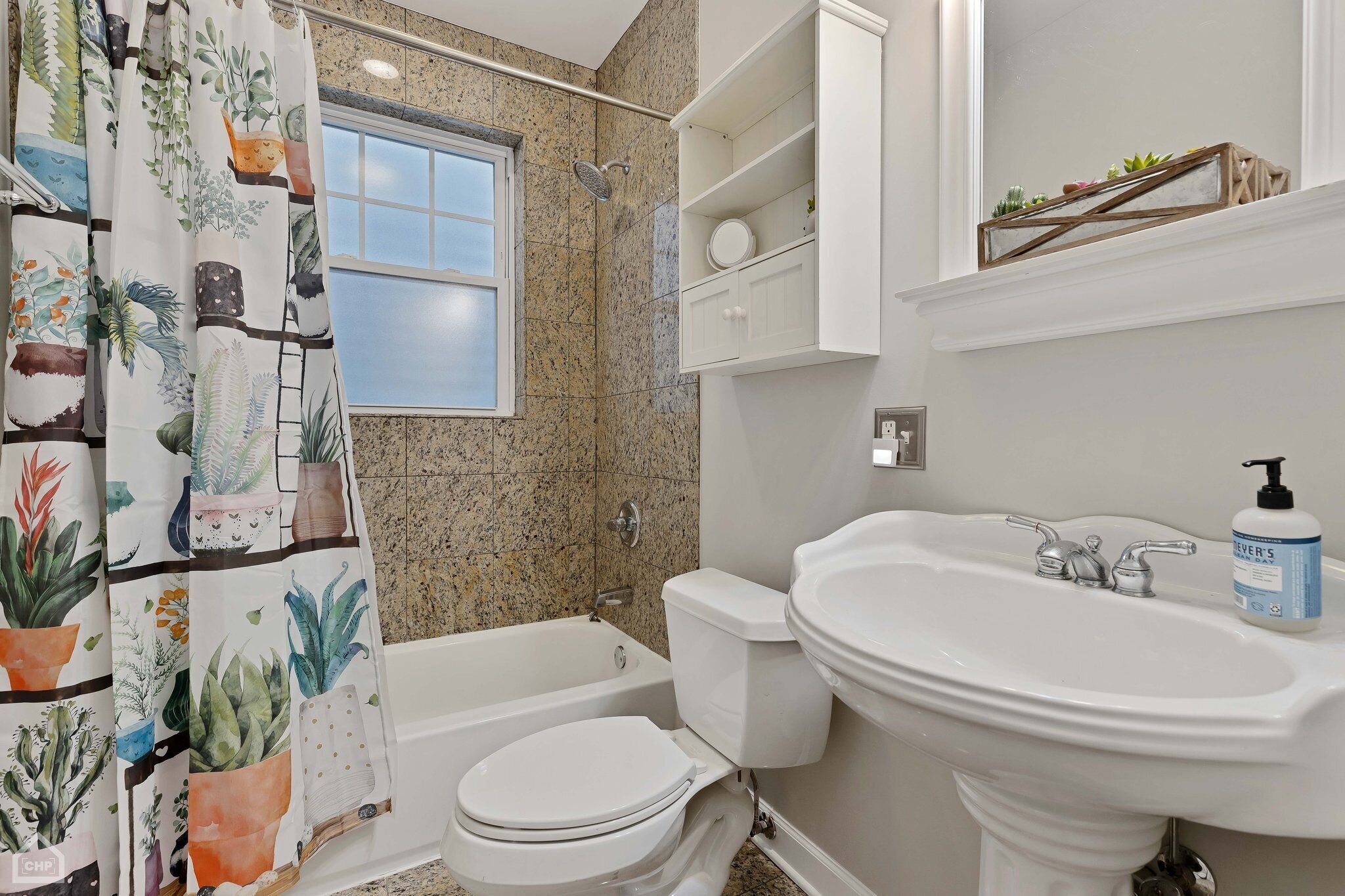 A bathroom with a bathtub, toilet, and sink.