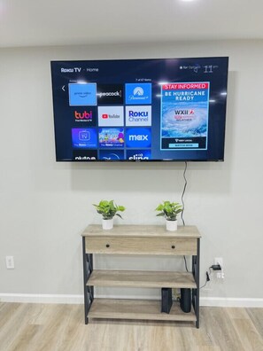 A television mounted on a wall displaying various streaming services. - Waterfront 3BR Home | Lake Views & Kayak Launch (Reidsville)