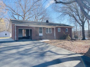 A single-story brick building with a covered entrance and a small attached garage. - Waterfront 3BR Home | Lake Views & Kayak Launch (Reidsville)