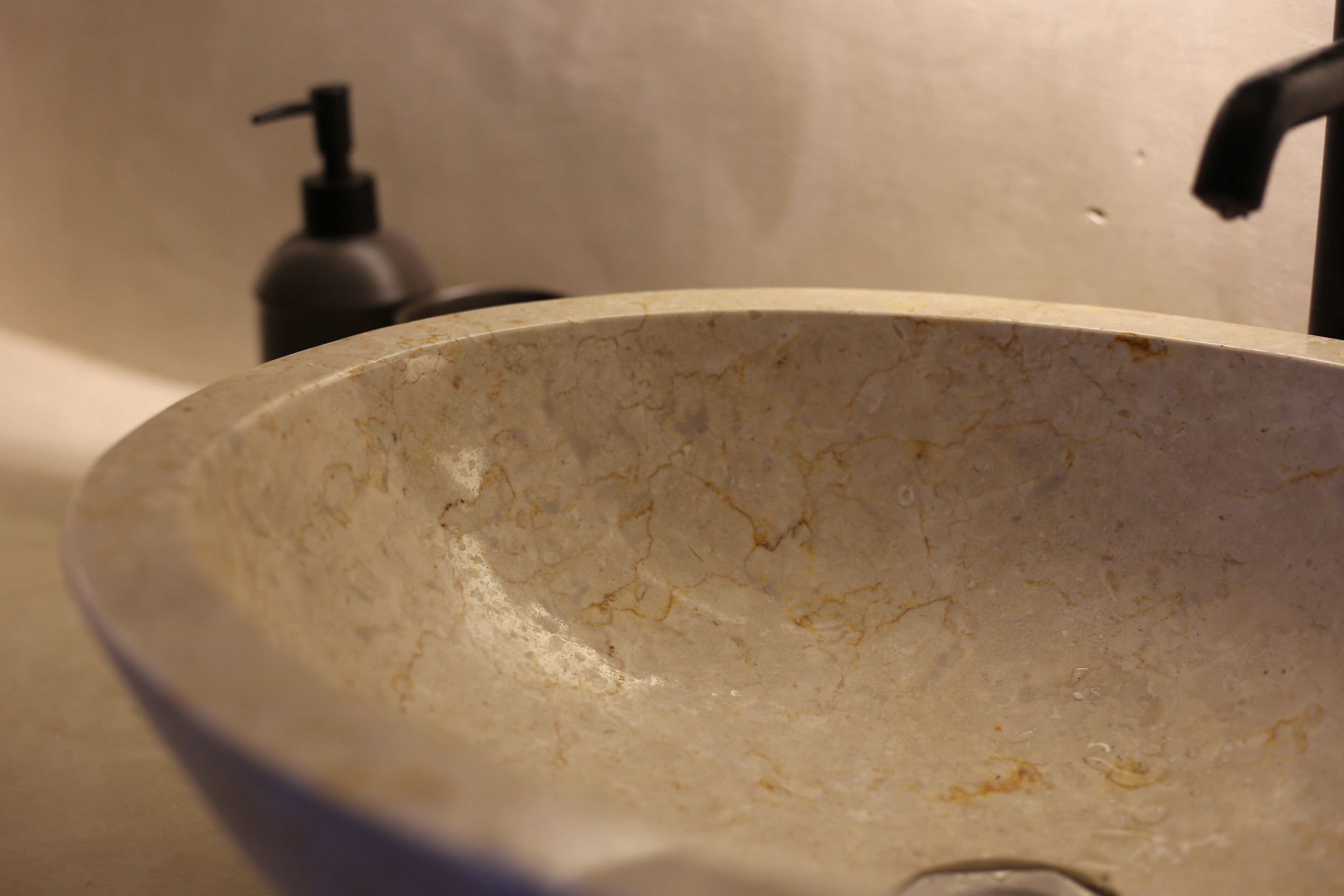 A bathroom sink with a marble basin.