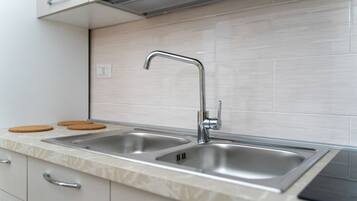 Fridge, stovetop, cookware/dishes/utensils, dining tables