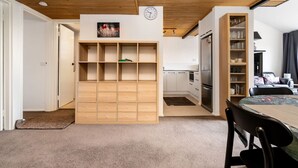 A compact living space with a kitchenette, a dining area, and a built-in shelving unit. - 3BR Loft Apt 1min to Kingston Foreshore! (Kingston)