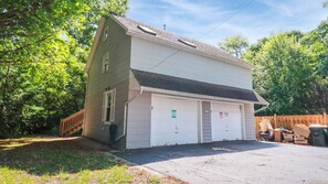A two-story house with a garage, a wooden deck, and a fenced yard. - Apt W/ heated garage Libertyville Near Naval Base (Libertyville)