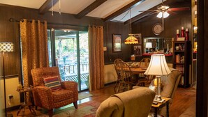 Una sala de estar acogedora con chimenea, comedor y estantería.