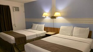 A hotel room with two single beds, a nightstand, and two wall-mounted lamps.