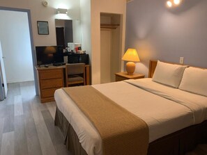 Comfortable retreat with a neatly made bed, desk area, and amenities.