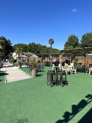 Relax in a serene outdoor space with comfortable seating and lush greenery.