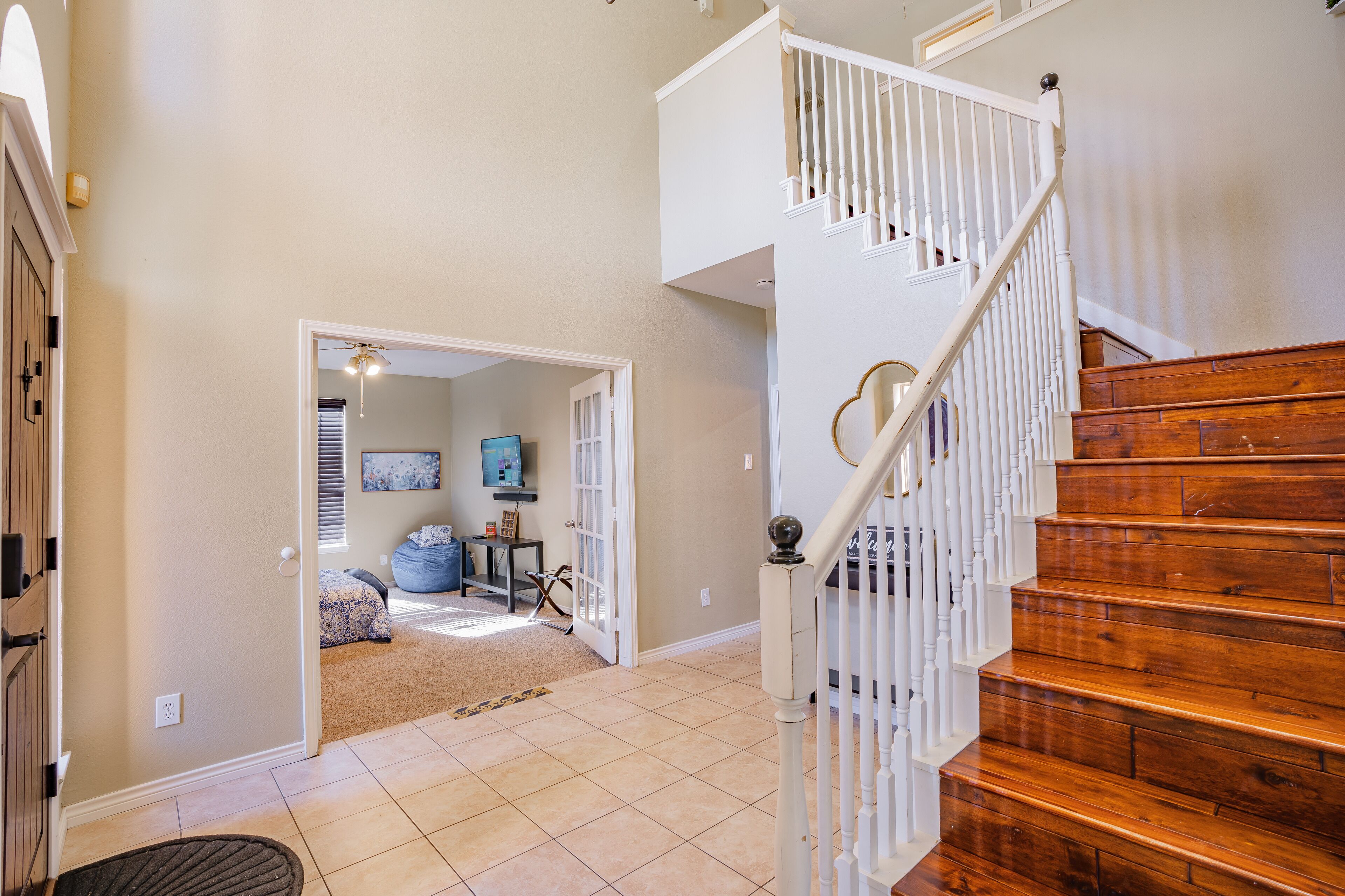 A staircase with white railings and wooden steps leading to an upper floor.