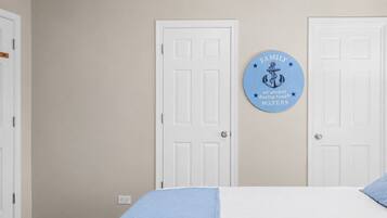 Closed closet door, tidied bed-11