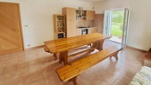 A compact kitchen with wooden cabinets and a built-in oven. - Green Paradise (Introdacqua)