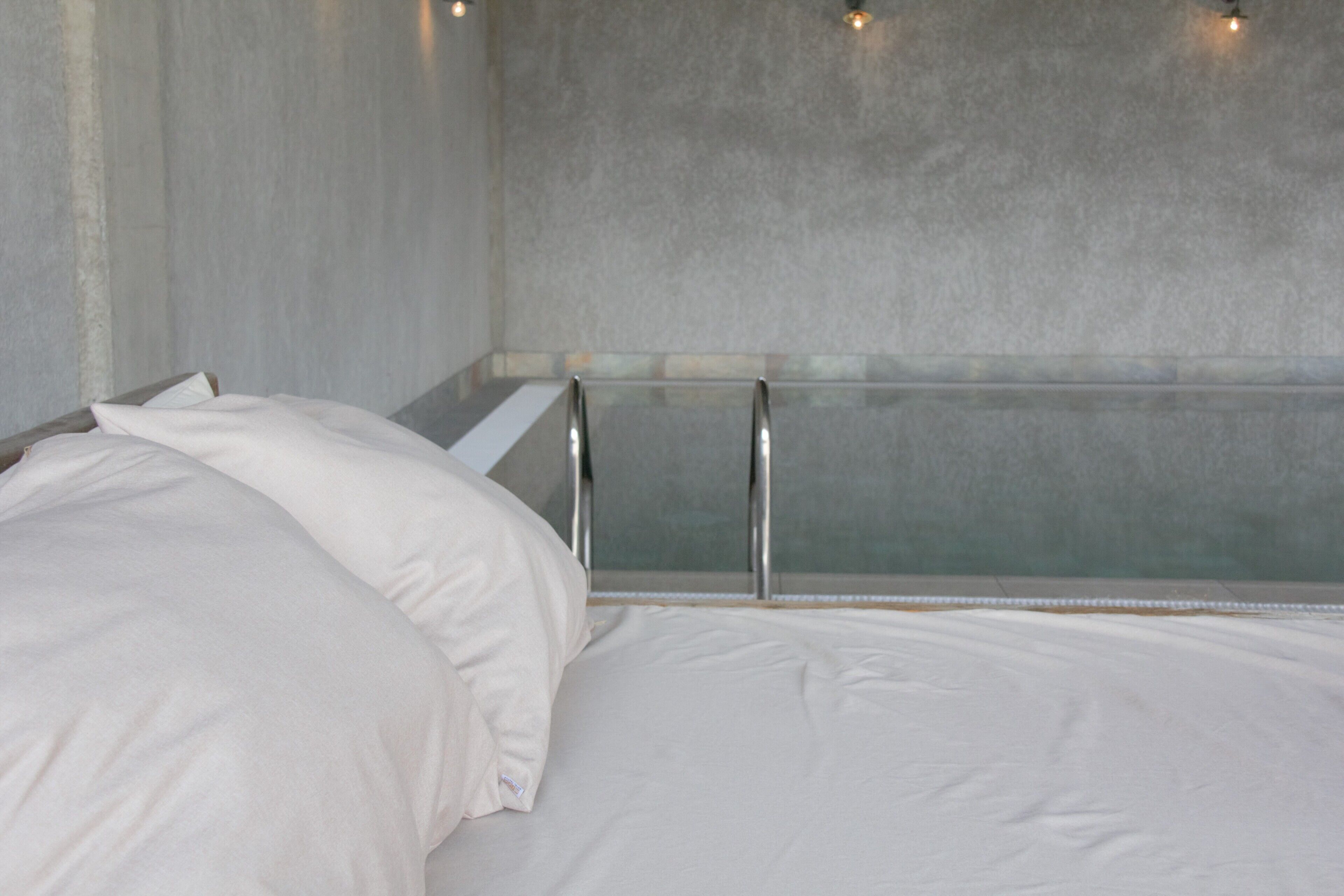 A modern bathroom with a bathtub, a shower area, and a glass partition.