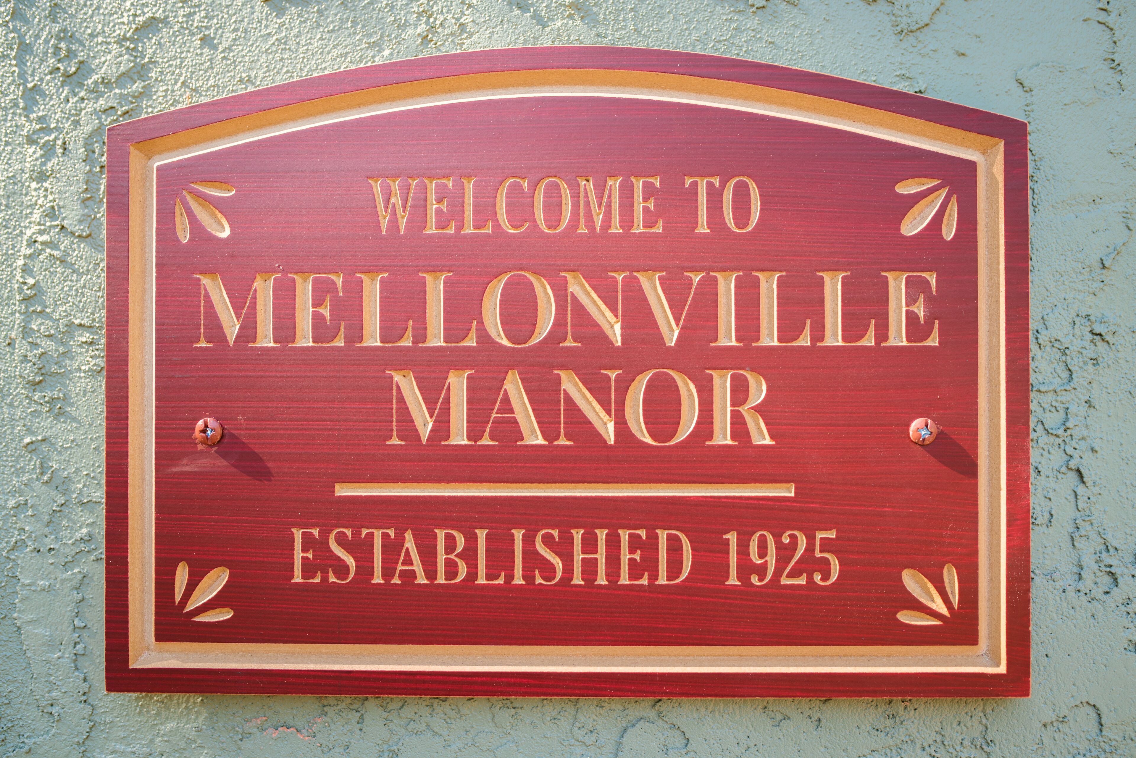 A wooden welcome sign for Mellonville Manor, established in 1925.
