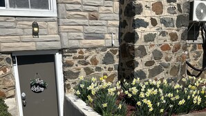 A stone building with a door labeled "Welcome".