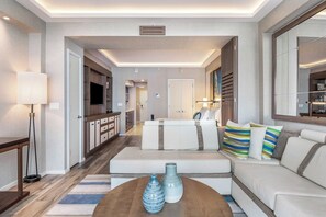 A modern living room with a sofa set, a coffee table, and a TV.
