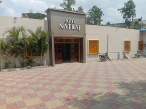 A hotel entrance with a sign reading "HOTEL NATRAJ" and a contact number. - 6 CR Hotel Natraj Aurangabad (Chhatrapati Sambhajinagar)