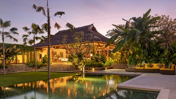 A resort with a swimming pool, a covered patio, and lush tropical vegetation. - Villa Nusantara  (Denpasar)