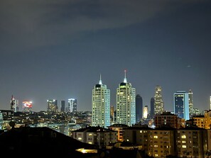 A nighttime cityscape with high-rise buildings and residential structures. - Prime Bosphorus (Istanbul)