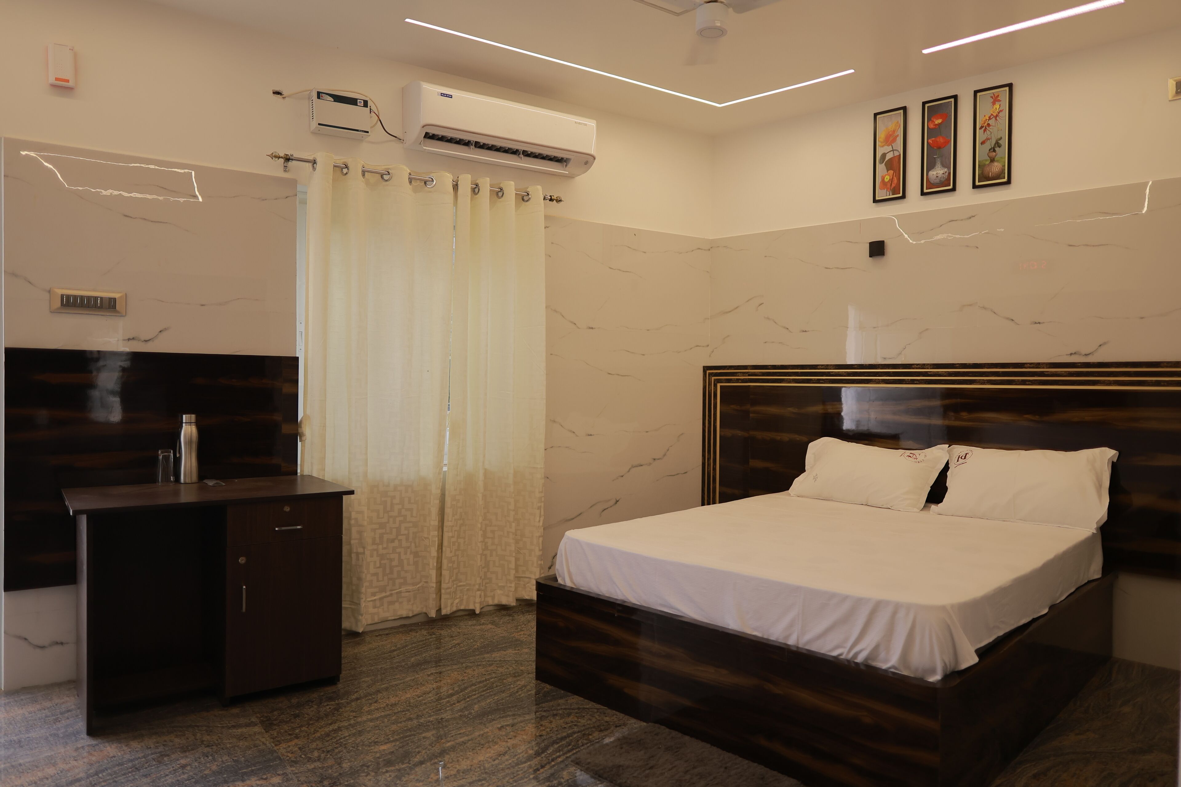 A modern bedroom with a wooden bed, a desk, and a shower area.
