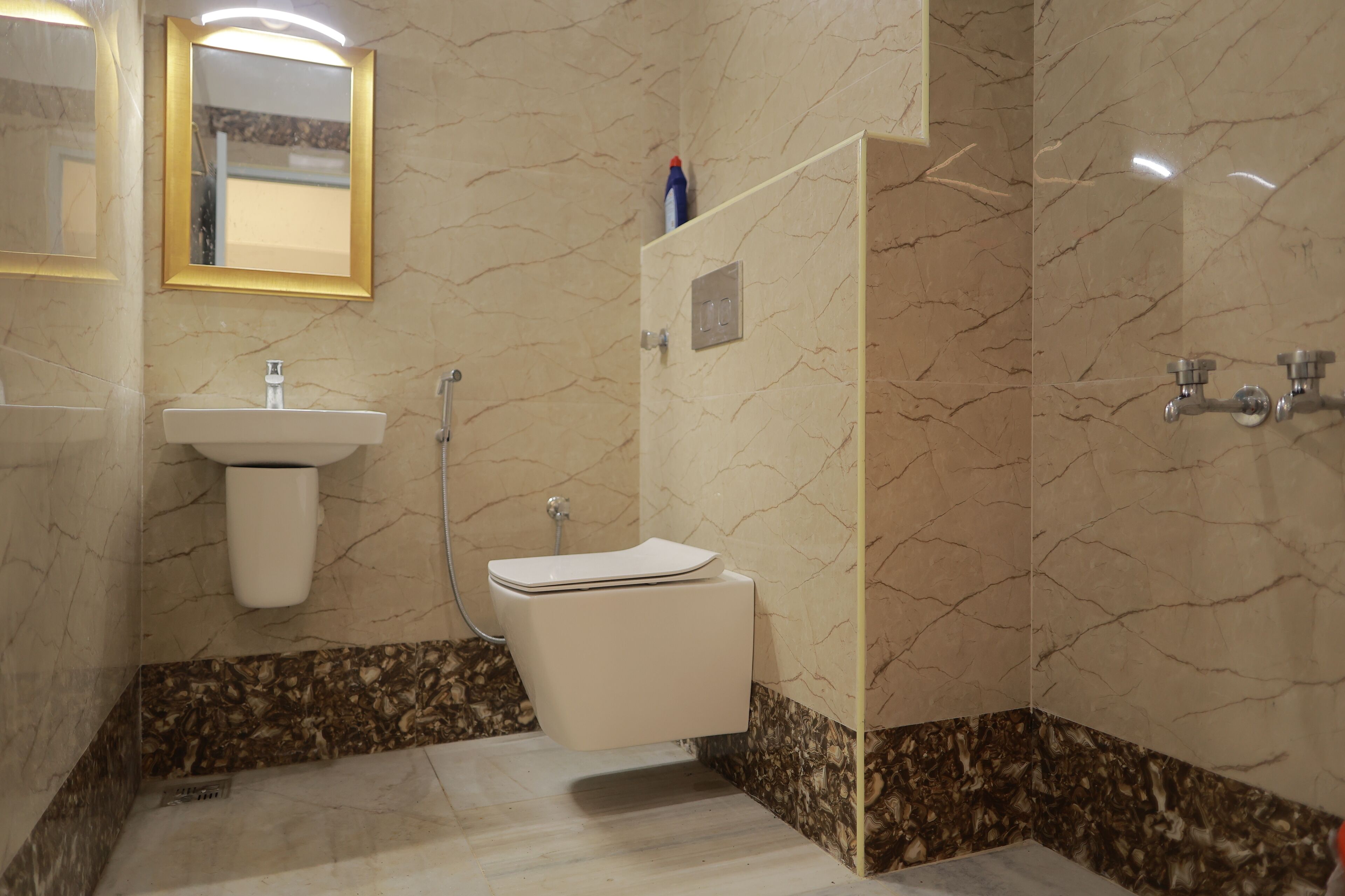 A bathroom with a toilet, sink, and shower.