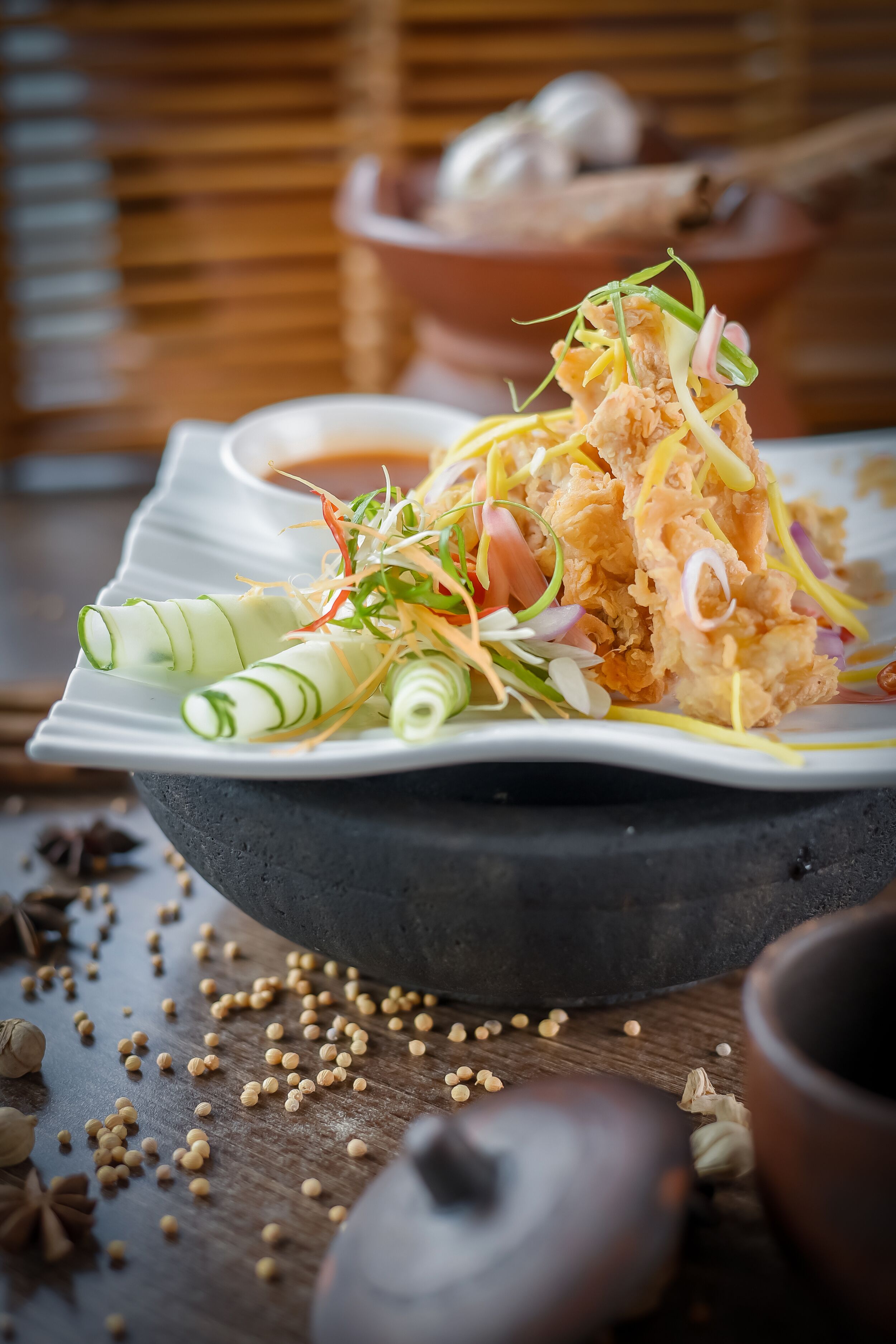 A plate of food with a variety of vegetables and garnishes.