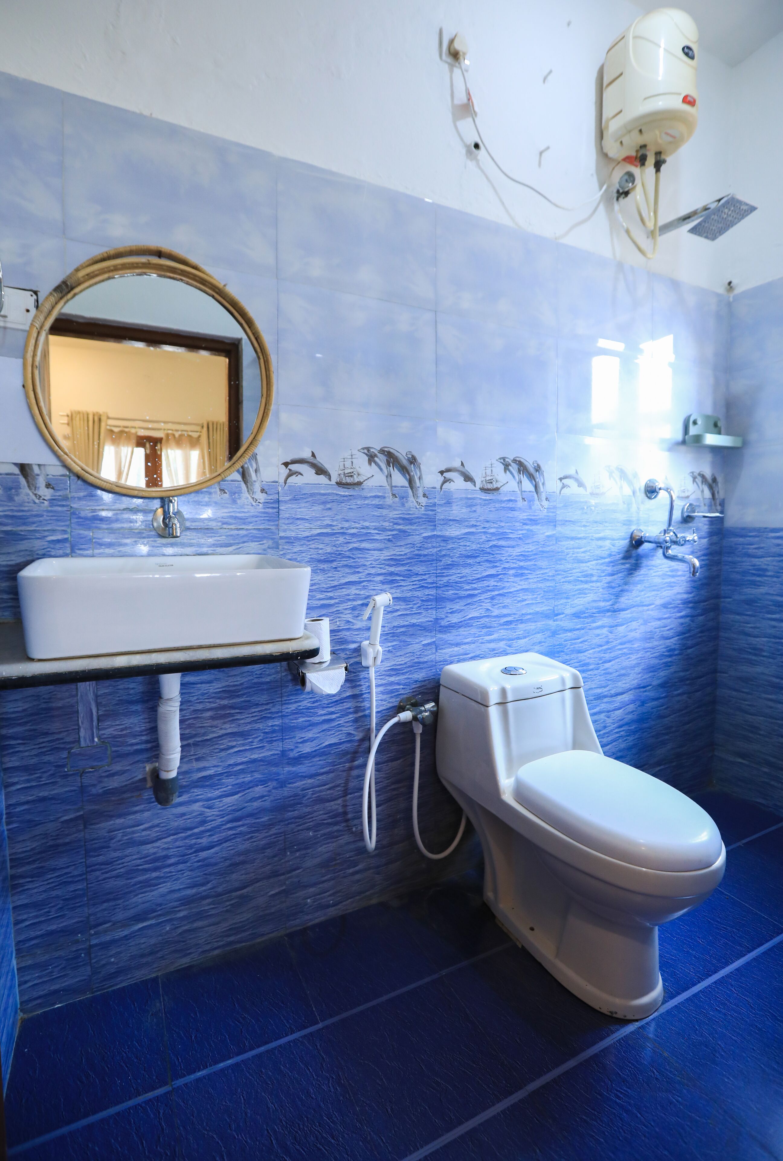 A bathroom with a white sink, toilet, and mirror.