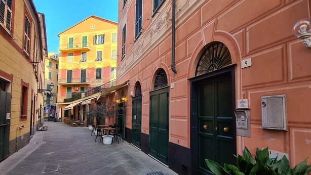 A narrow street lined with buildings, including a building with a green door and a number '9' sign. - Santa in Caruggio- PortofinoVacanze (Santa Margherita Ligure)
