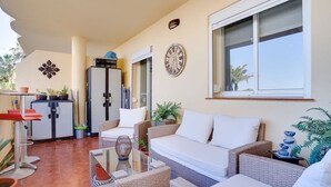 A living area with a sofa, chairs, a glass coffee table, and a refrigerator. - Unique accommodation with a private pool, sea view, terrace, 300m to Aldea Beach (Manilva)