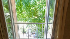 A room with a window overlooking a balcony.