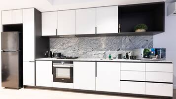 Fridge, stovetop, dishwasher, coffee/tea maker