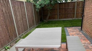 Une terrasse avec une table et des bancs en métal.