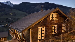 A wooden cabin with a sloped roof, a staircase leading to a porch, and a view of a valley with mountains in the background. - Family Chalet for 8/9, 5 mins to Village Center, Mountain Views, WiFi (Arêches-Beaufort)