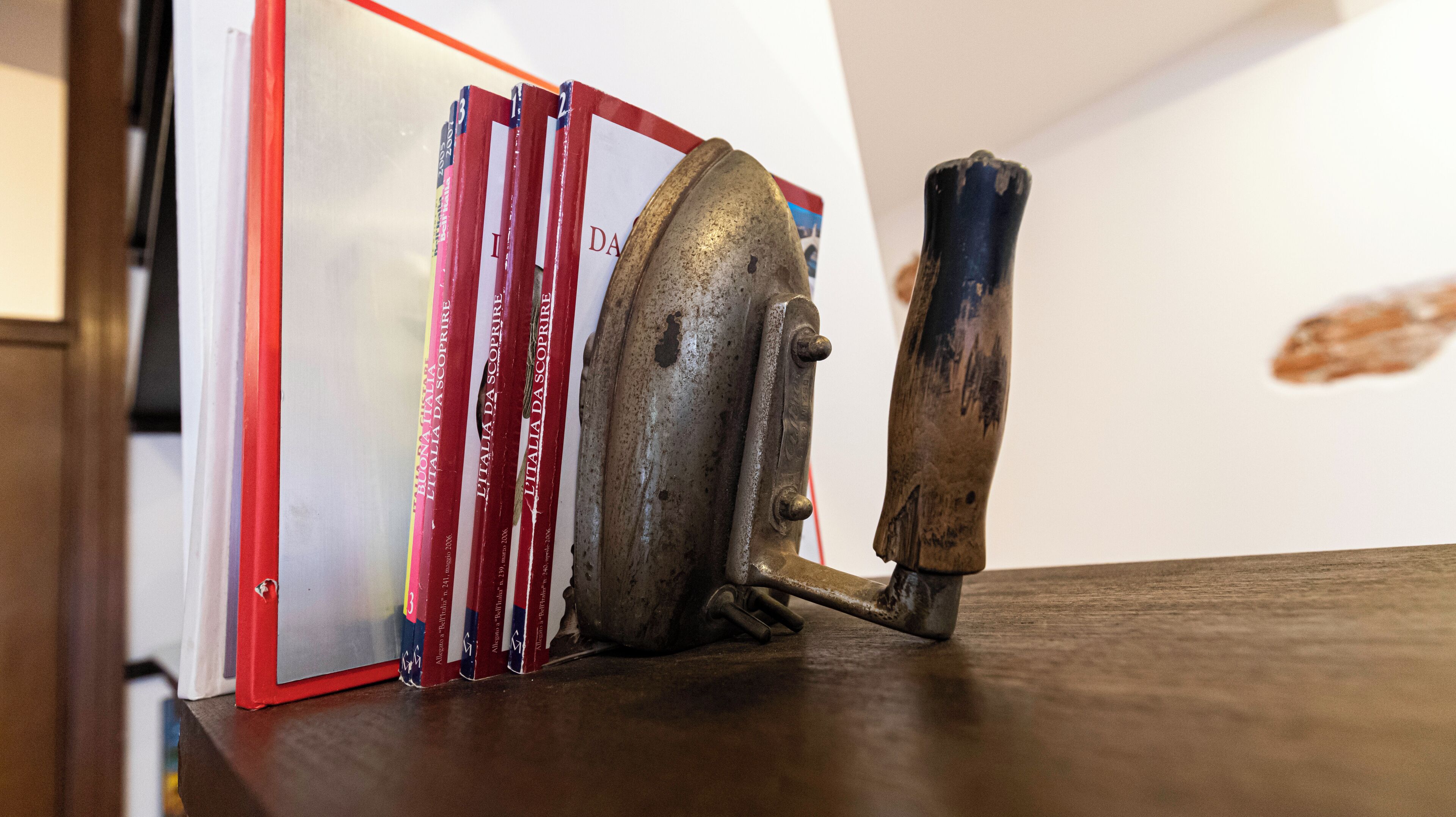 A metal object with a handle on a wooden surface.