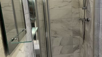 Shower, hair dryer, towels, toilet paper