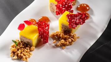 A dessert on a white rectangular plate with a dark background.