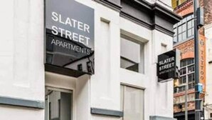 A building with a sign reading "Slater Street Apartments".