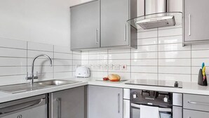 A modern kitchen with stainless steel appliances, a dishwasher, and a built-in oven. - Host & Stay | Slater Street Apartment IV (Liverpool)