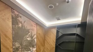 A room with a massage table, a sink, and a shelf unit. - S Class Hotel Convention Center (Gaziantep)