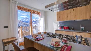 Family Chalet, Multiple Bedrooms (Chalet Merveille Ski In - Ski Out) | Private kitchen | Fridge, microwave, oven, stovetop