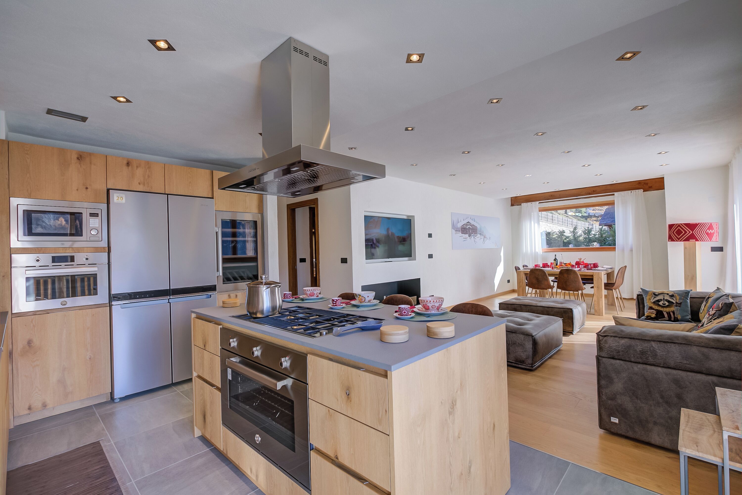 A modern kitchen with wooden cabinets, stainless steel appliances, and a central island.