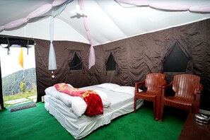 A tented room with a bed, a chair, and a view of the outdoors. - MYSTERY HILLS RESORT (Kandaghat)