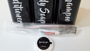 Three black bottles with white pumps labeled "Conditioner," "Baby Shampoo," and "Shampoo" on a white surface. - The Old Guest House - R2 (London)