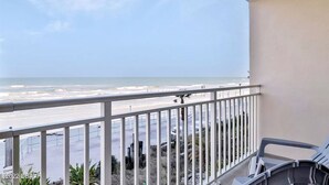 A balcony with a view of the beach and ocean. - Heart of Daytona 1 bedroom w/kitchen, sleeps 4, private balcony, fireplace, pool (Daytona Beach)