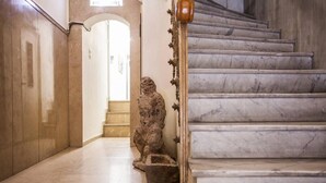 A marble staircase with a stone sculpture at the base. - Exclusive New Modern Apartment at Syntagma Square (Athens)
