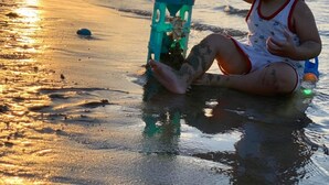 A child playing with a toy on a beach at sunset. - LA GAI HOMESTAY HOI AN (Da Nang)