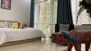 A bedroom with a bed, pillows, a stuffed toy, and a decorative item. - LA GAI HOMESTAY HOI AN (Da Nang)