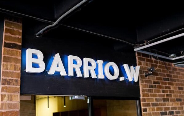A storefront with a sign that reads "BARRIO.W".
