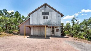 A rustic barn-style building with a large open garage area.