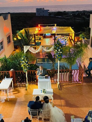 Guests gather at the stage for an intimate ceremony overlooking the sea.